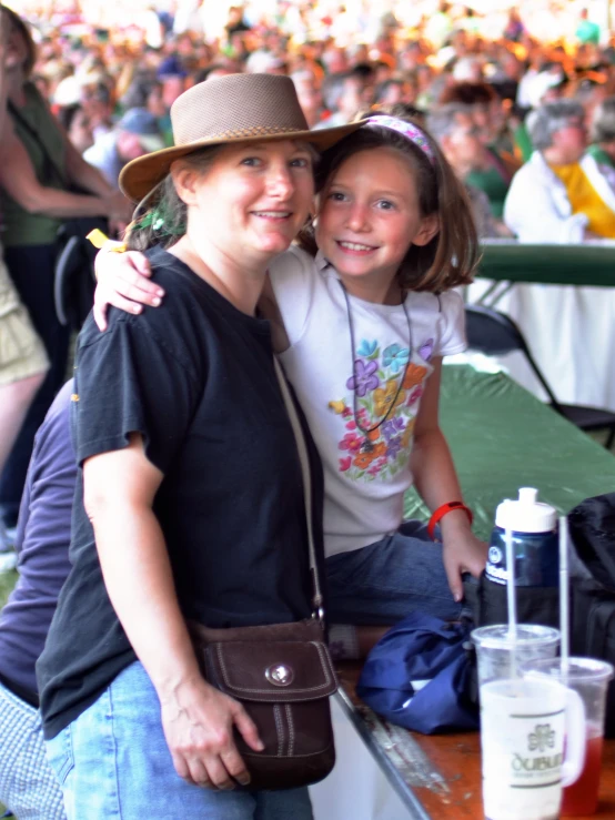 a woman posing with a little girl