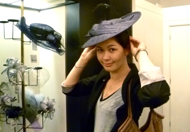 young lady wearing a hat and carrying a purse