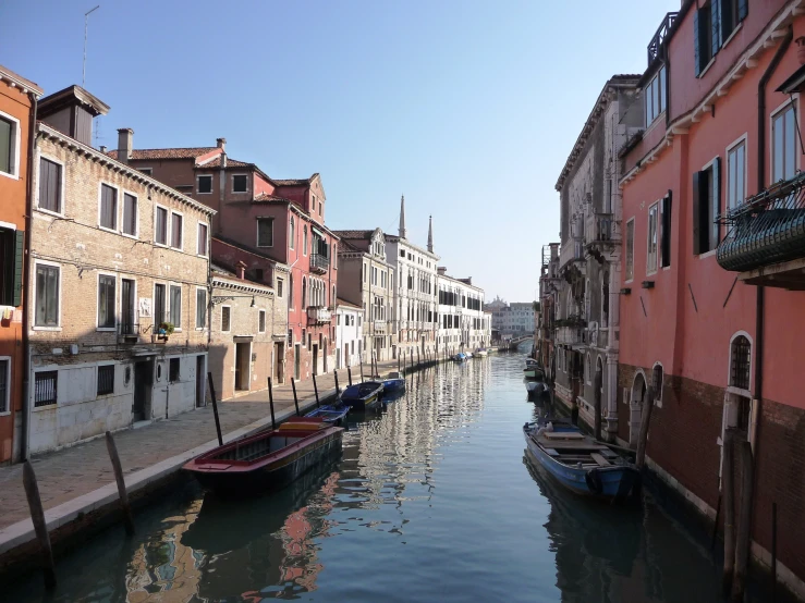 some houses and boats on the water and blue sky