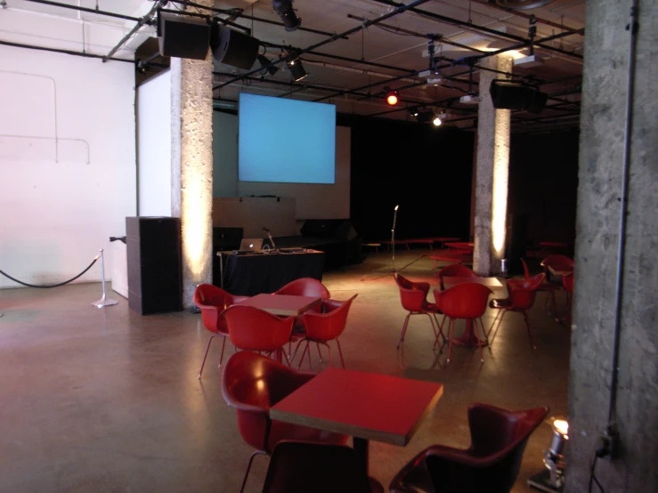 tables are sitting inside a room and are red