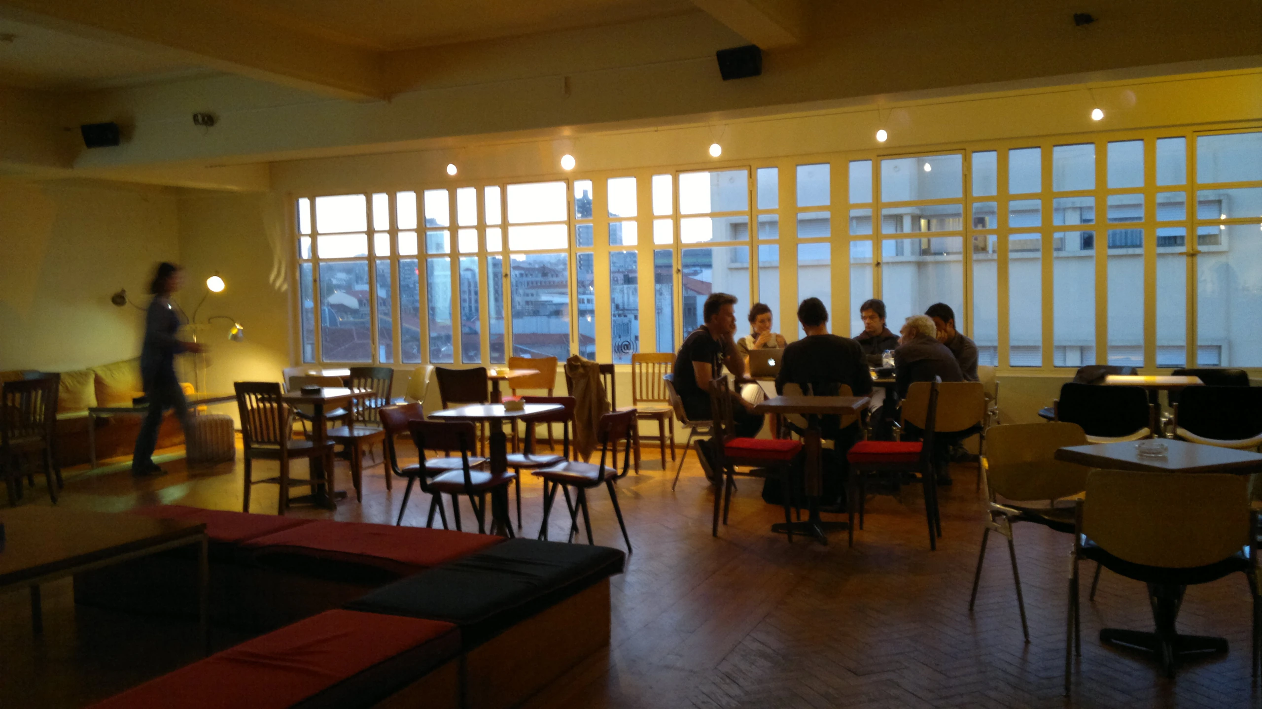 people sitting at tables in an industrial style cafeteria