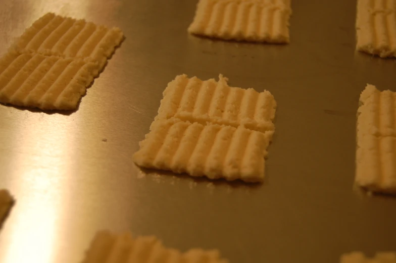 small pieces of waffle bread on a metal surface