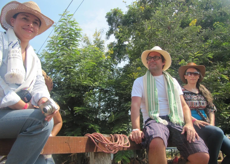 two men and one woman are sitting together