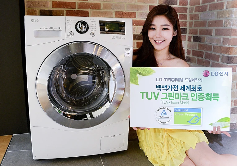 a woman sitting next to an appliance with a sign