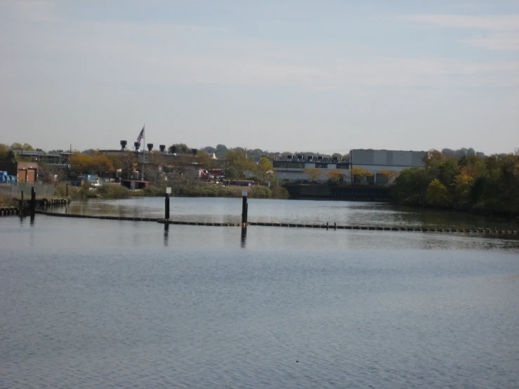 two wooden posts at the edge of a body of water