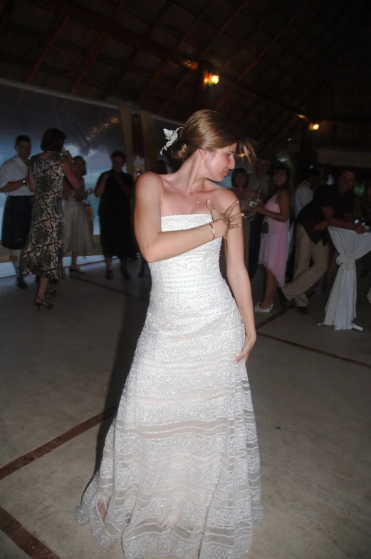 a woman in a white gown on a dance floor