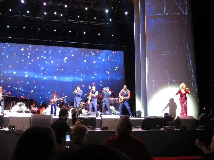 band performing on a stage in front of people