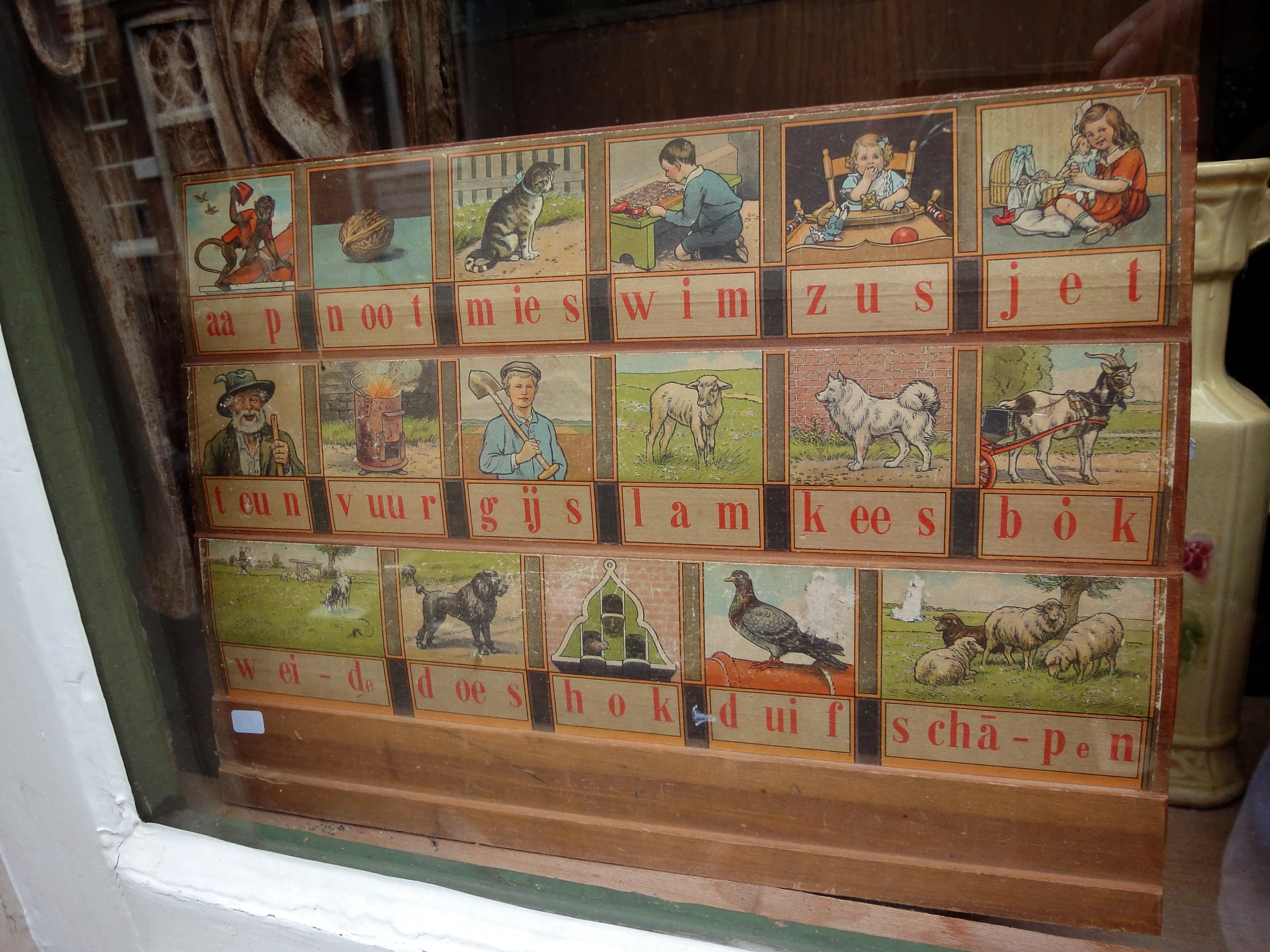 several different pictures on a window sill in a store