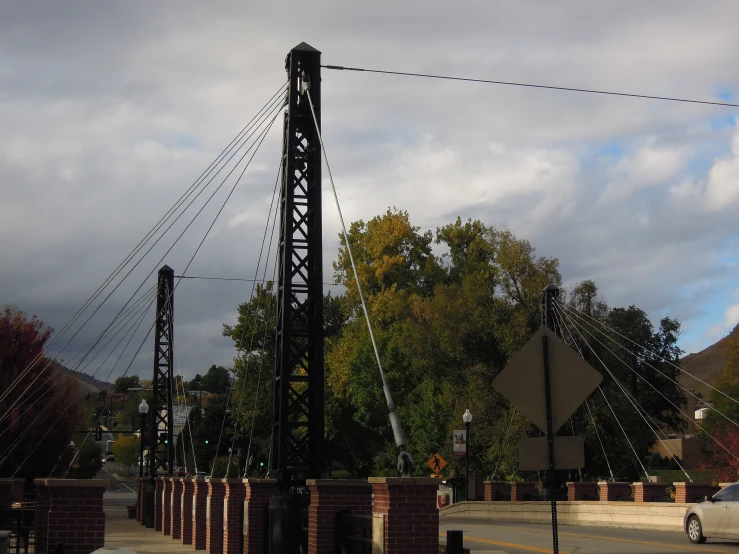 a large metal pole sitting on the side of a road