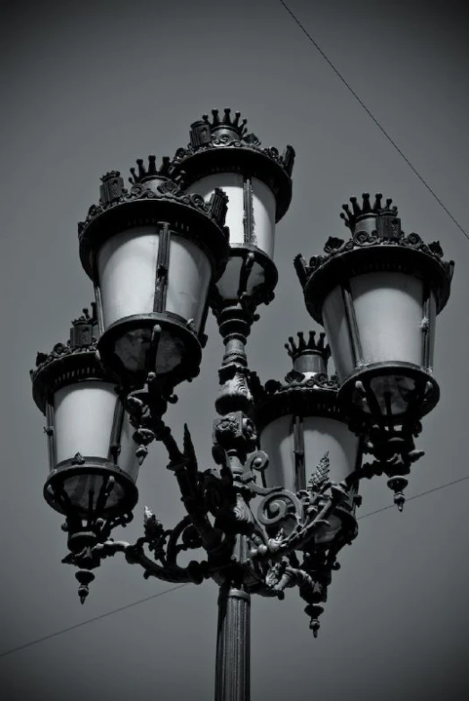 a very old fashioned looking light post on the street