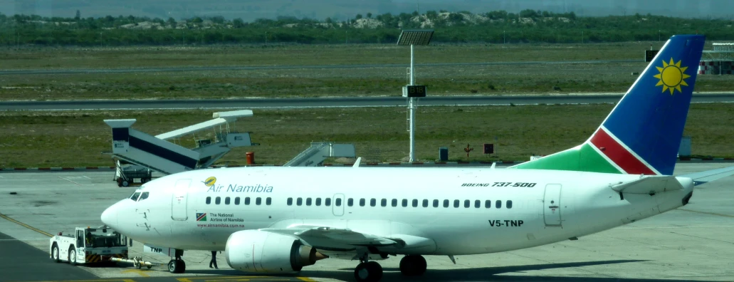 an airplane sits on a tarmac at the airport