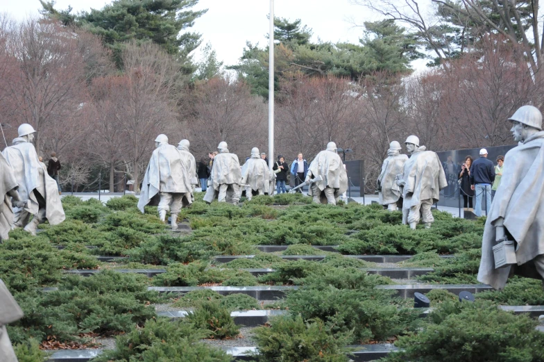 a group of people that are looking at statues