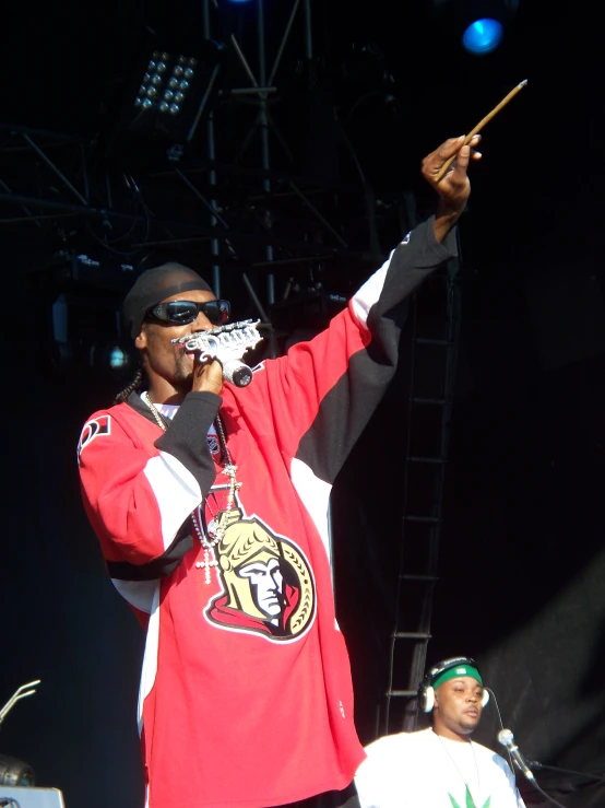 a man standing in front of a microphone on a stage