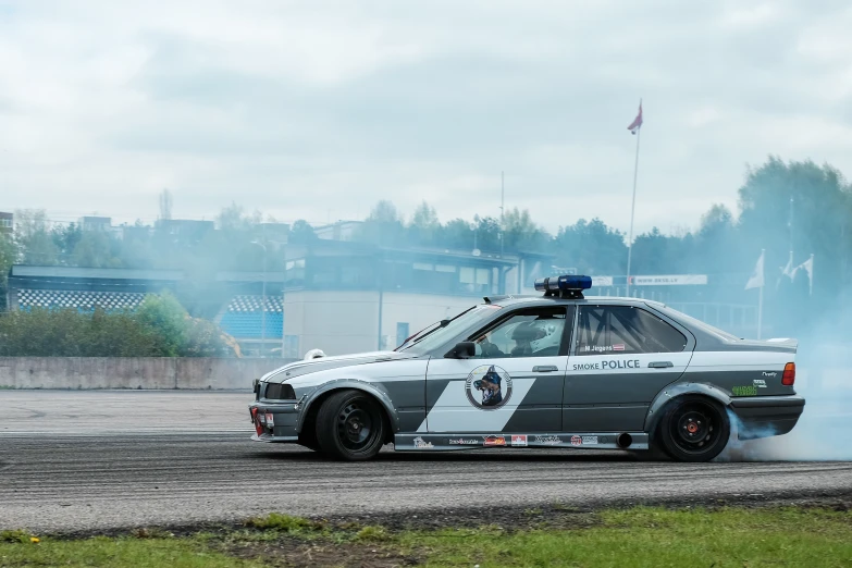 a race car with smoke pouring out of it