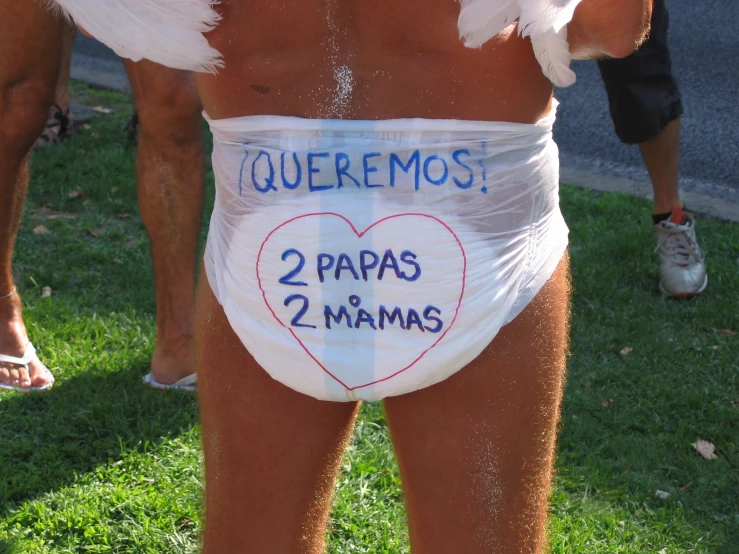 a man in underwear that is decorated with writing