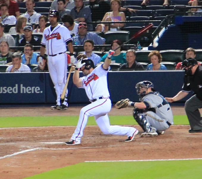 a baseball player at home plate preparing to hit the ball