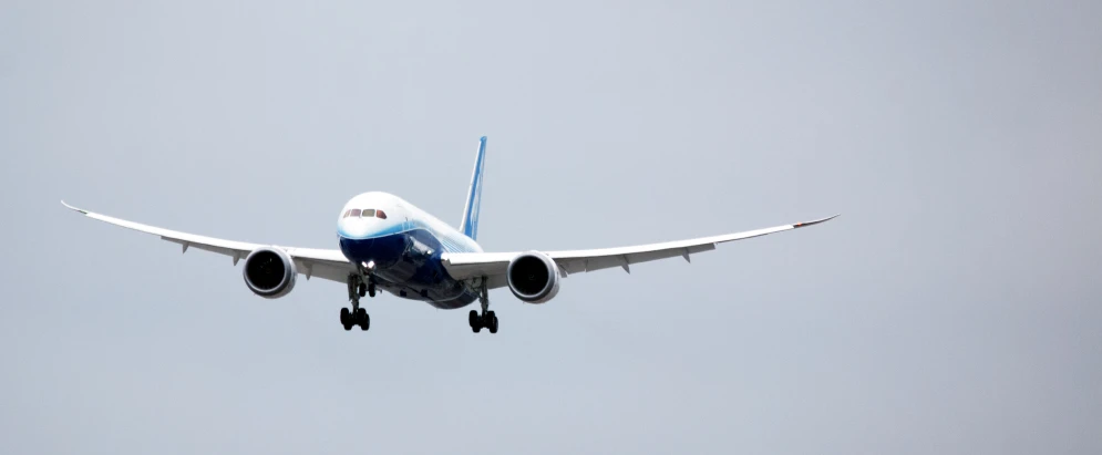 the blue and white plane is ascending into the sky