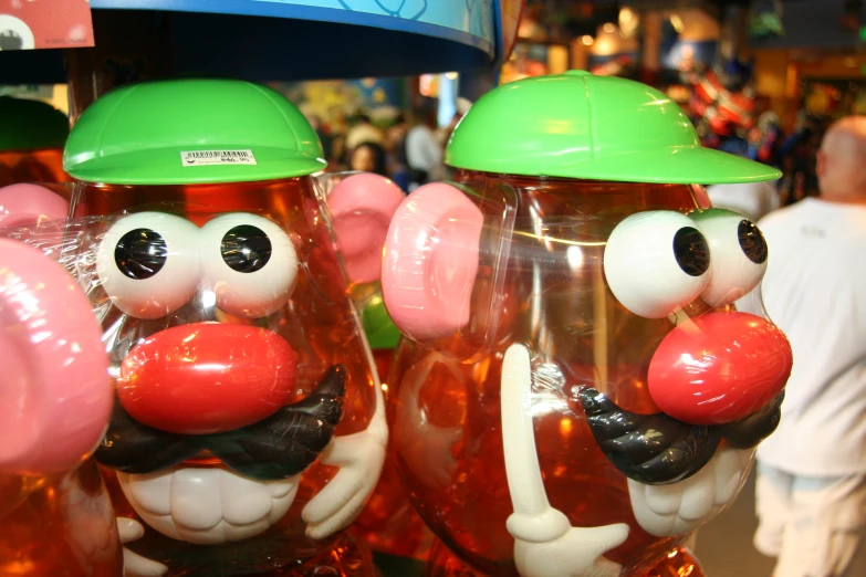 a row of gummy bubbles wearing hats with faces