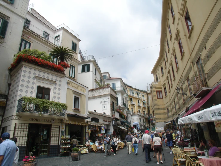 many people and some buildings with street signs