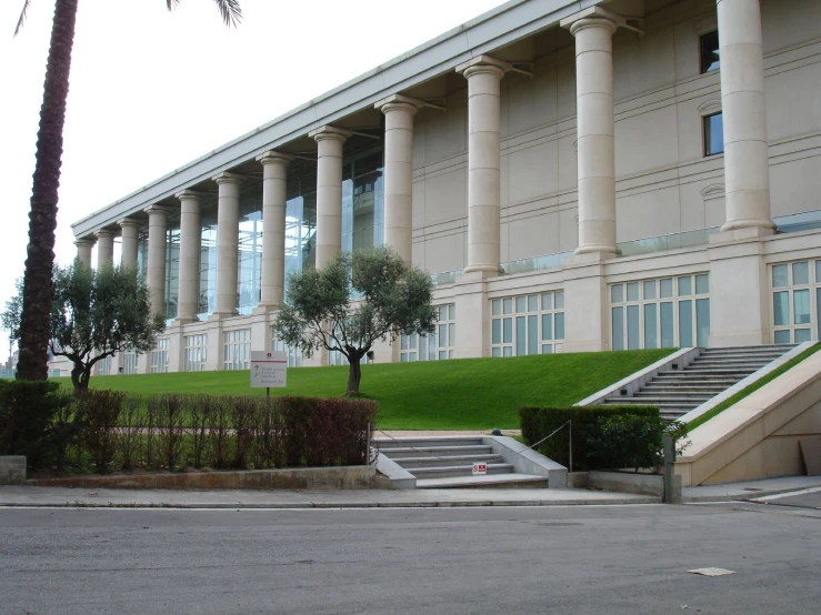 a large stone building with columns next to it