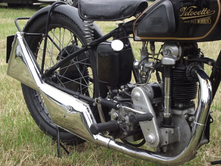 motorcycle parked in grass with front end showing