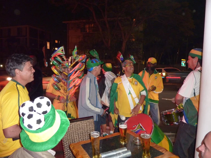 a group of men standing next to each other holding soccer ball