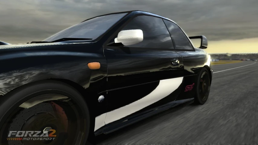 a black car driving on the road with cloudy skies