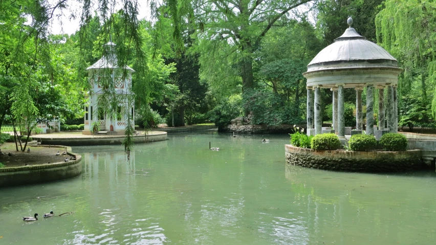 the gazebos are situated in a pond surrounded by trees