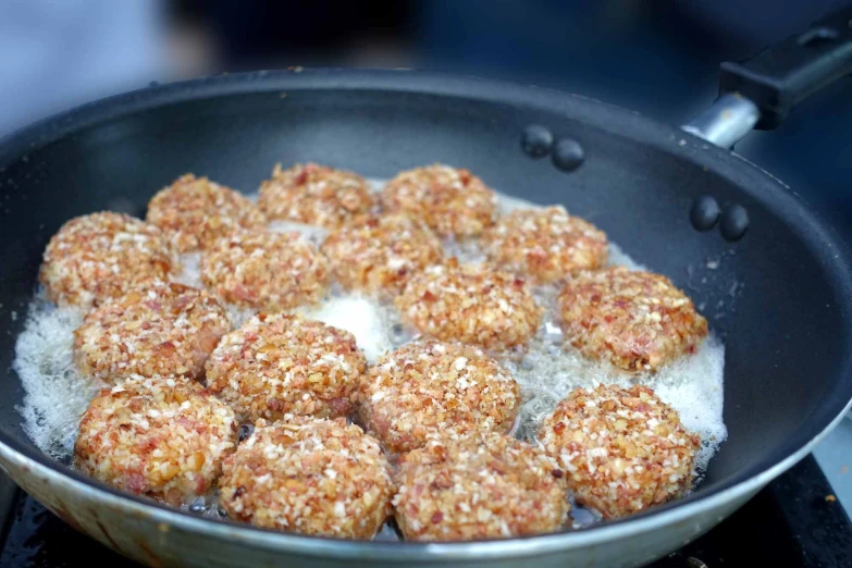 meatballs are being cooked in a set on the stove