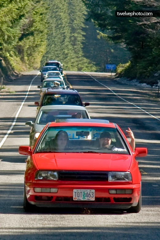 a row of cars parked in line on the side of a street