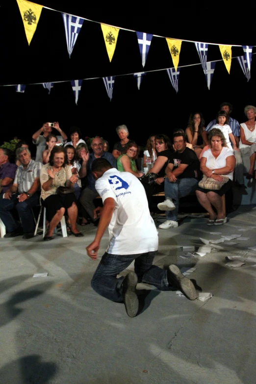 the man is performing tricks for crowd members