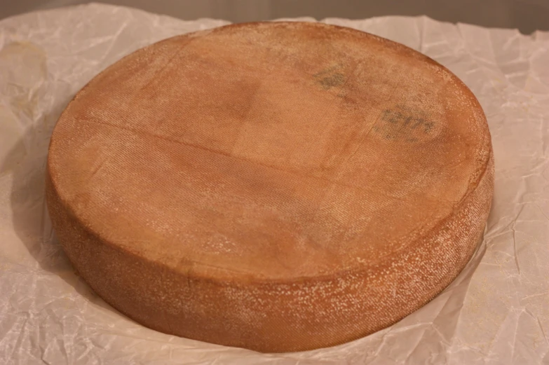 a very big round pizza crust on some paper
