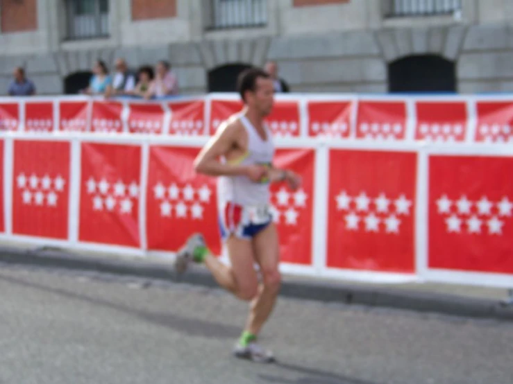 a blurry po of a man running in front of a sign