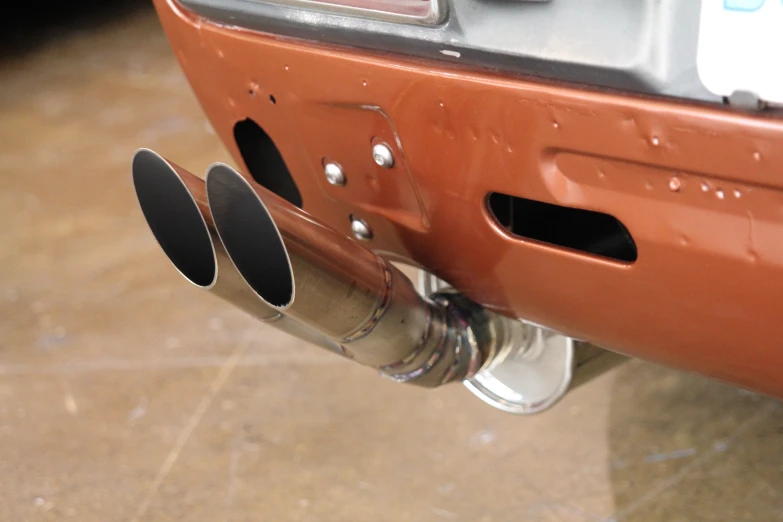 a close up of a exhaust pipe and back end