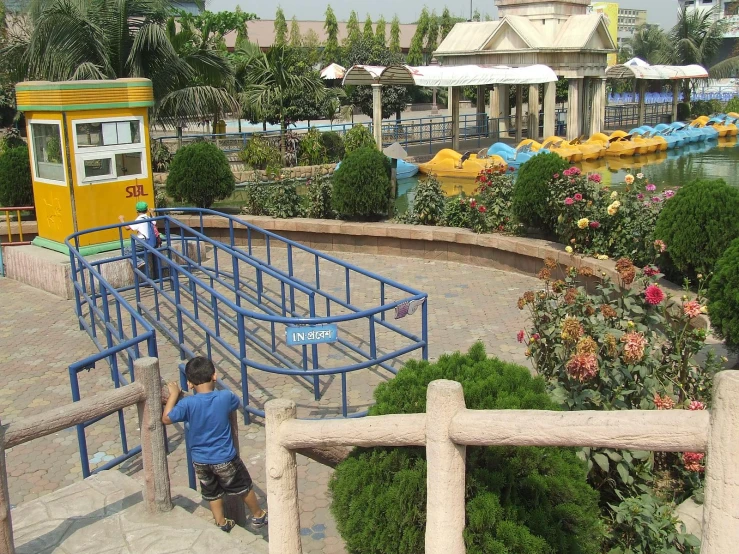 a man stands by a train in an amut park