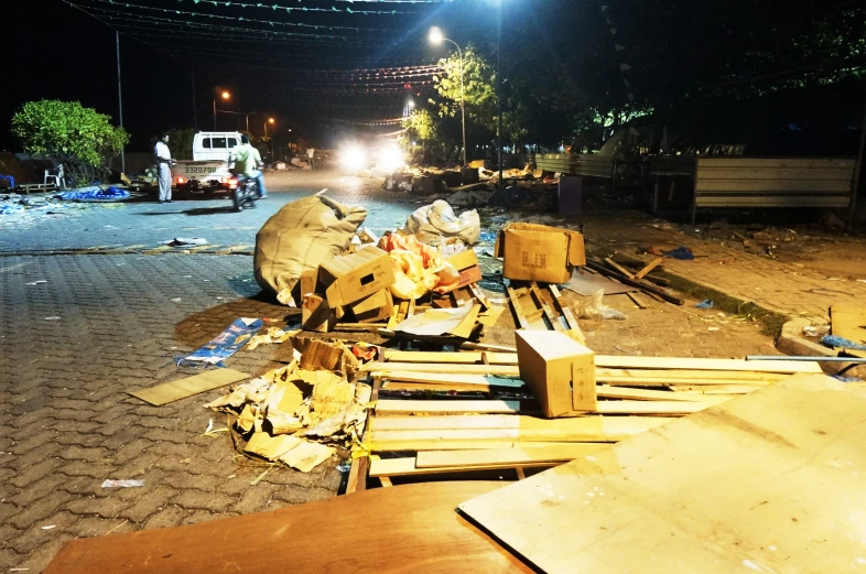 a large pile of rubble and items next to a fire truck