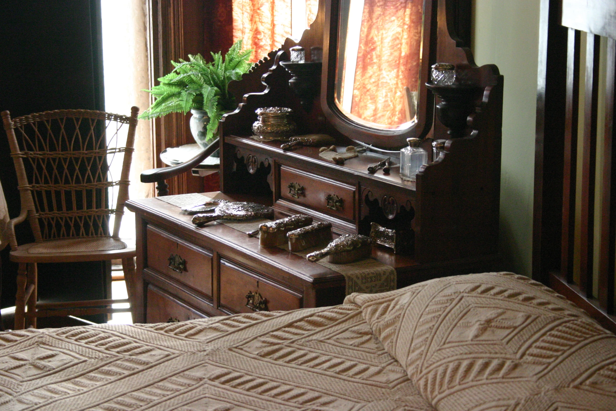 a very old fashioned dresser in a dimly lit room