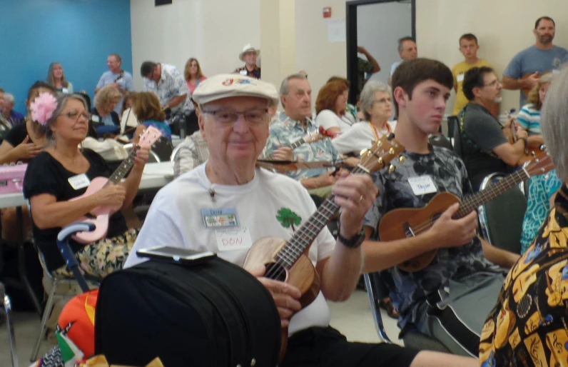 a man sitting with a group of people in a room