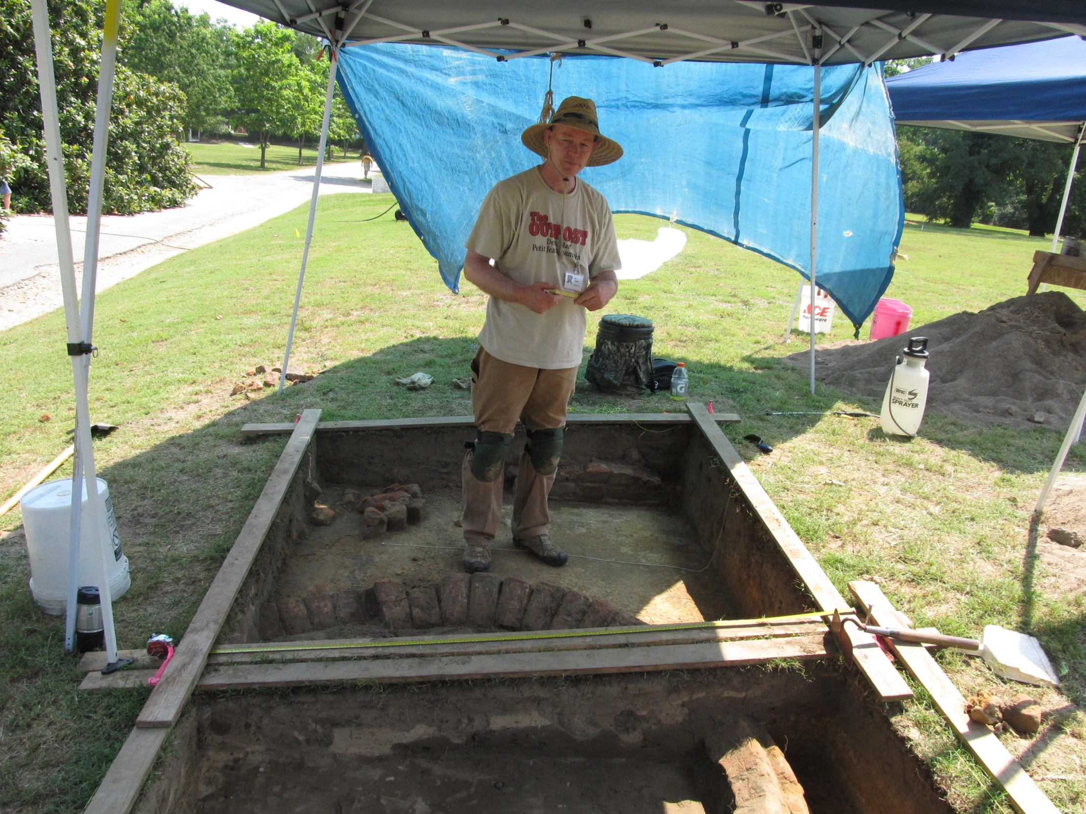 a man in a straw hat holding a baseball bat in his hand