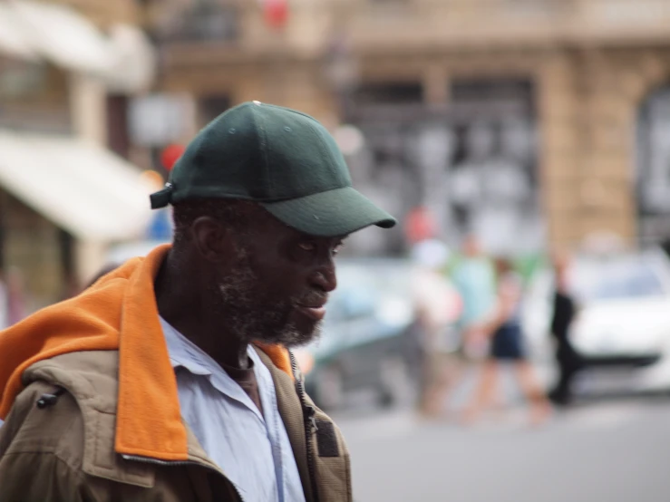 an older man is walking on the sidewalk