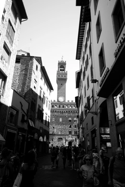 people are standing on a crowded street and some buildings