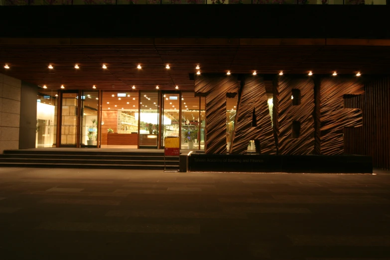 the front entrance of an elegant building at night