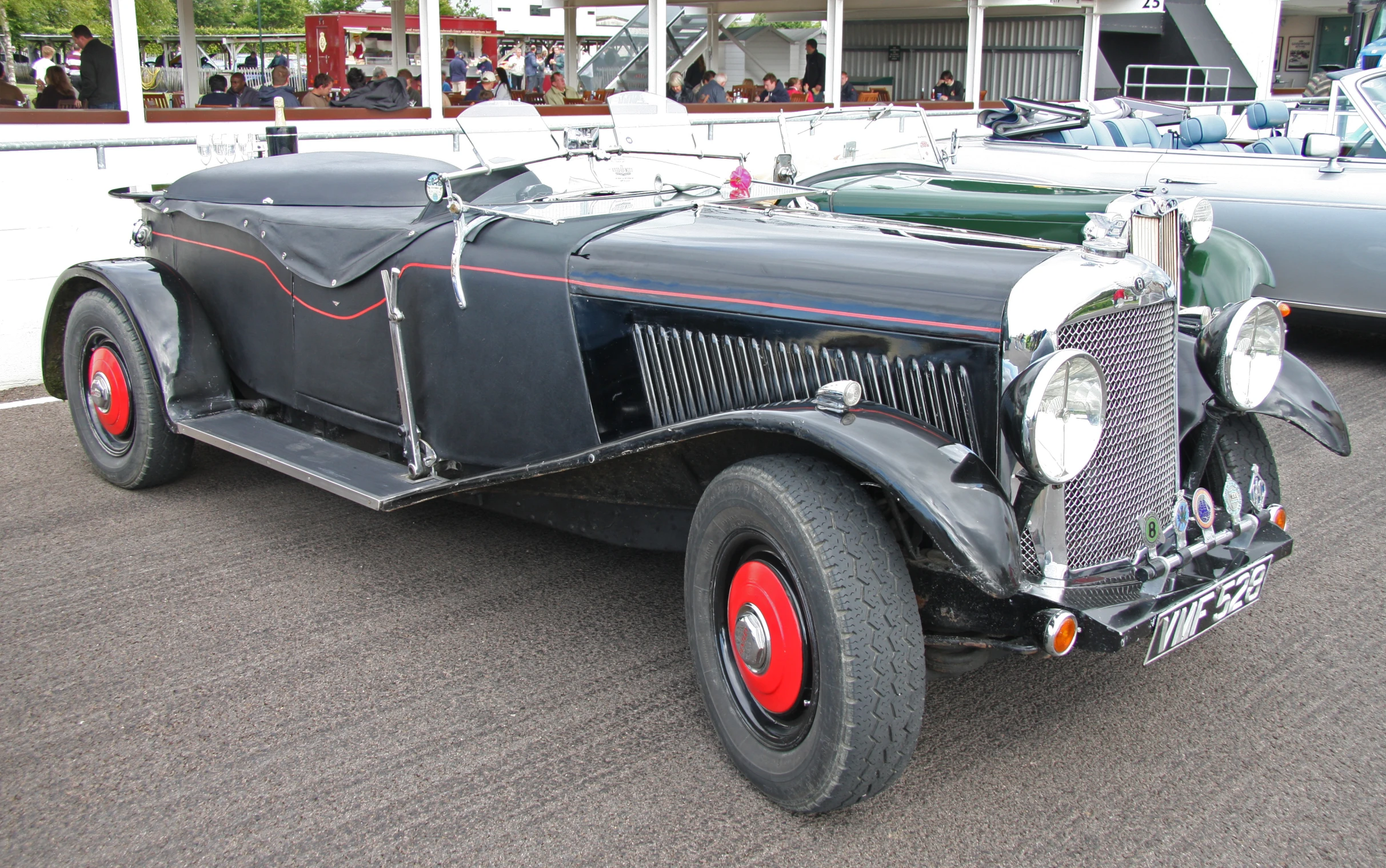 a vintage car parked in front of a white building