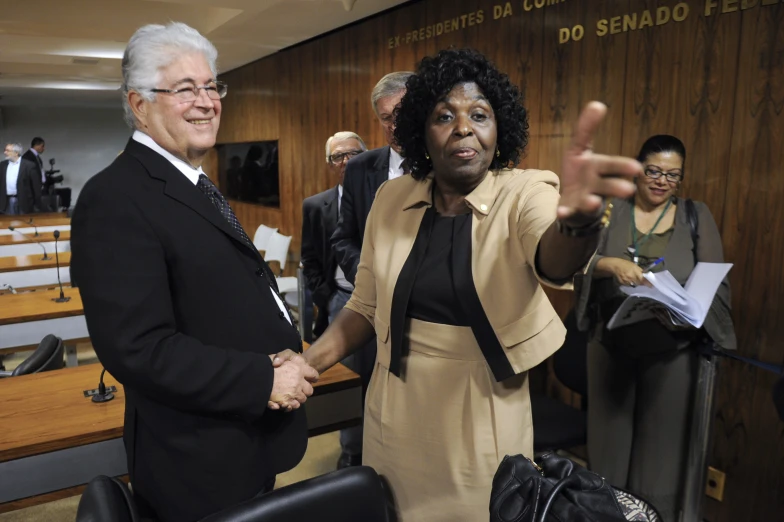 a woman shaking a man's hand during a meeting