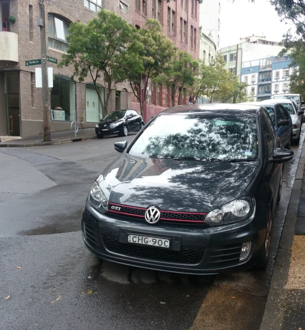 a black car sitting in the middle of a street