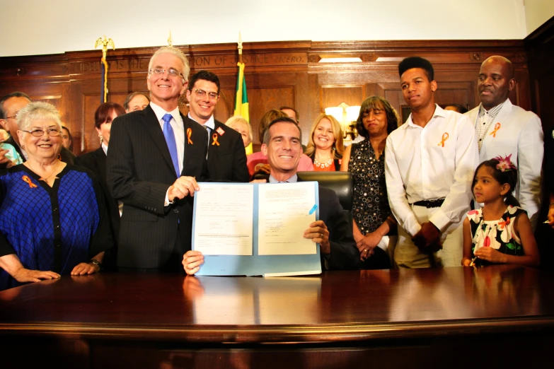 an image of a man holding a signed document