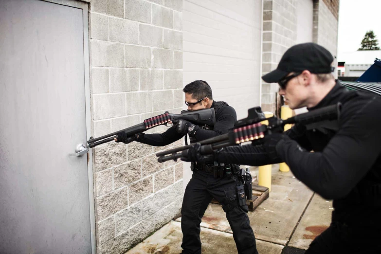 a couple of guys with guns are in the street