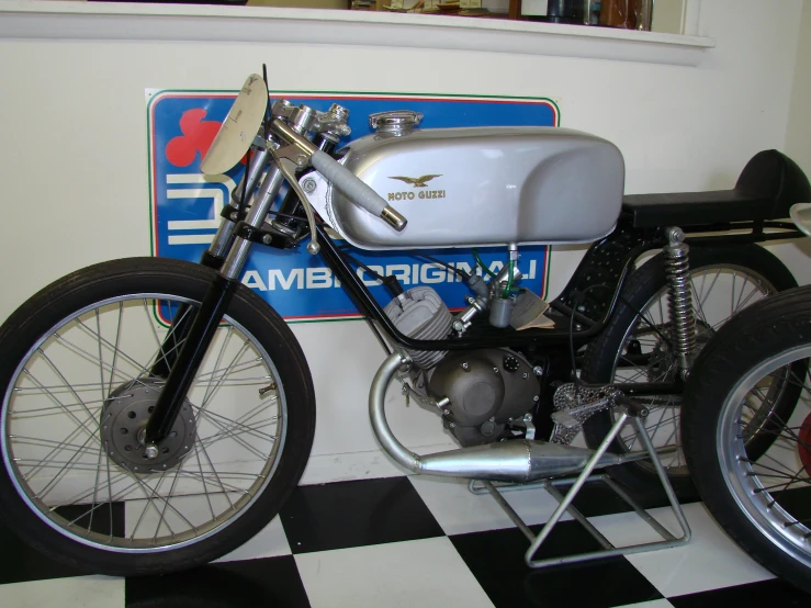 a motorcycle that is sitting on a checkerboard floor