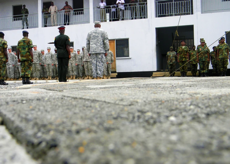 a group of soldiers standing outside of a building