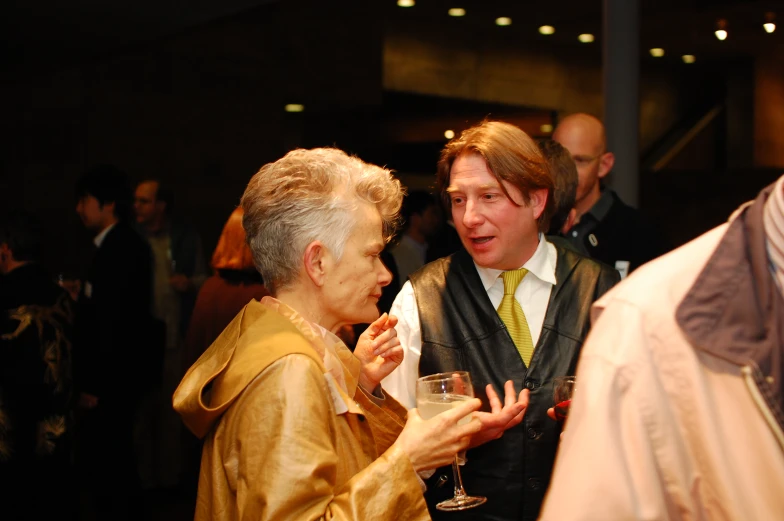 a woman talks to an elderly lady at a gathering